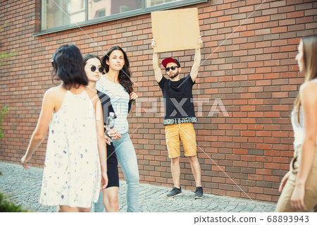 Dude with sign - man stands protesting things that annoy him 68893943