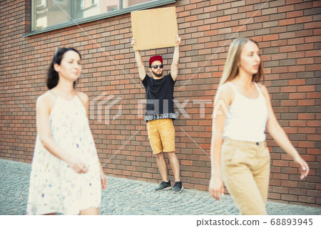 Dude with sign - man stands protesting things that annoy him 68893945