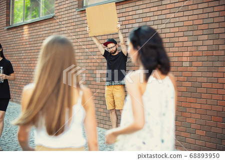 Dude with sign - man stands protesting things that annoy him 68893950