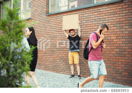 Dude with sign - man stands protesting things that annoy him 68893953