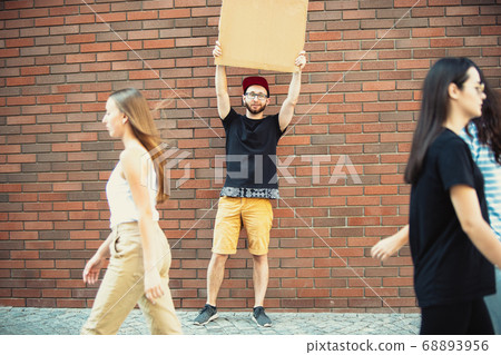 Dude with sign - man stands protesting things that annoy him 68893956