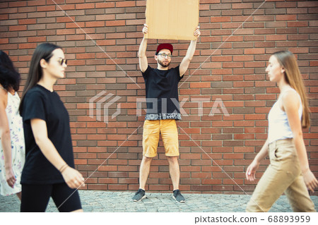 Dude with sign - man stands protesting things that annoy him 68893959
