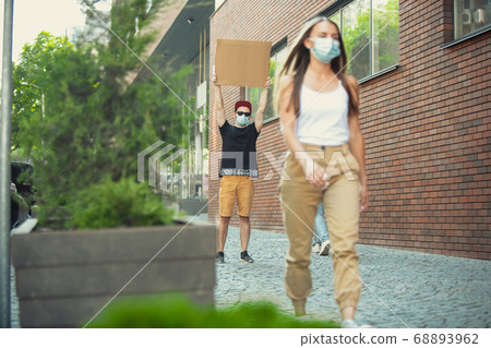 Dude with sign - man stands protesting things that annoy him 68893962