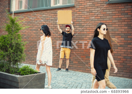 Dude with sign - man stands protesting things that annoy him 68893966