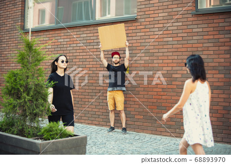 Dude with sign - man stands protesting things that annoy him 68893970
