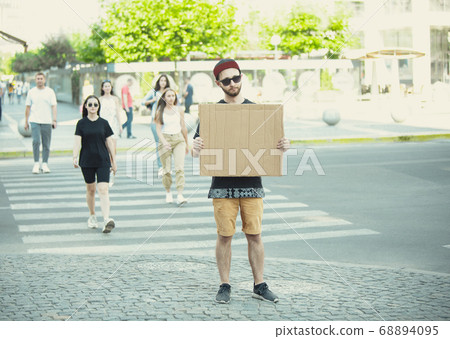 Dude with sign - man stands protesting things that annoy him 68894095
