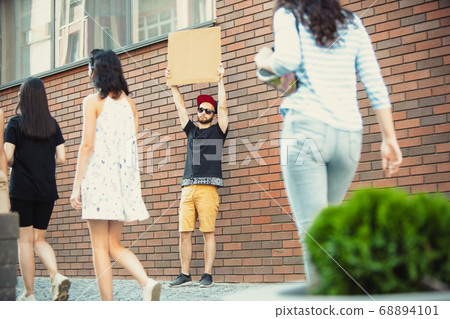 Dude with sign - man stands protesting things that annoy him 68894101