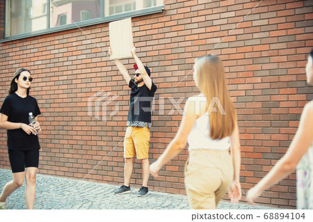 Dude with sign - man stands protesting things that annoy him 68894104