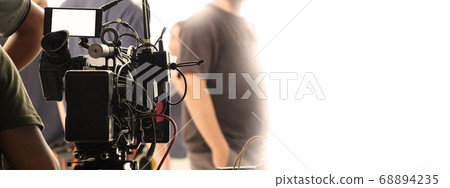 Behind the scenes of video recording or filming online movie by 8K high definition digital camera and professional monitor. And flare lighting set up with film crew team in the studio production. Behind the scenes of video recording or filming online movie by 8K high definition digital camera and professional monitor. And flare lighting set up with film crew team in the studio production. 68894235