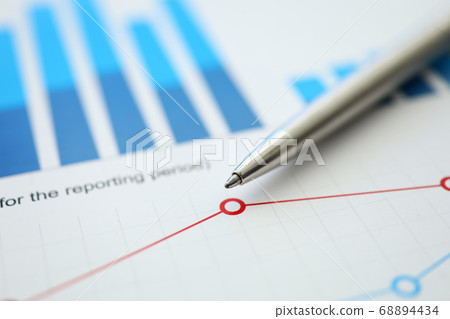 On table is financial report with chart and pen On table is financial report with chart and pen 68894434