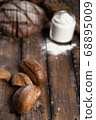 Rye buns and flour on table 68895009