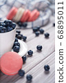 Fresh blueberries and macaroon on table 68895011