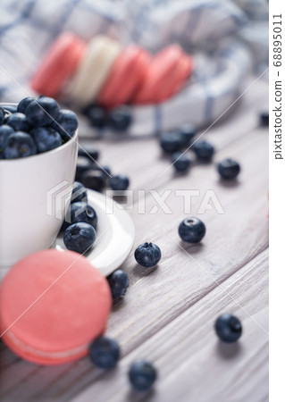 Fresh blueberries and macaroon on table Fresh blueberries and macaroon on table 68895011