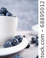 Ripe blueberries on plate and in bowl 68895012