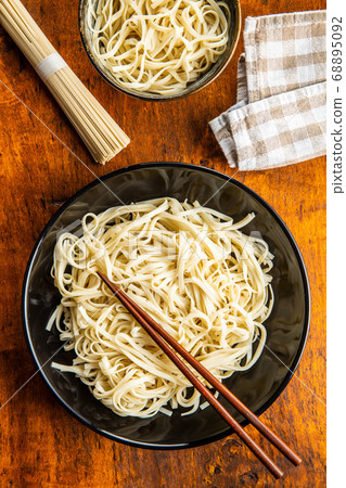 Cooked udon noodles. Traditional Japanese noodles. Cooked udon noodles. Traditional Japanese noodles. 68895092