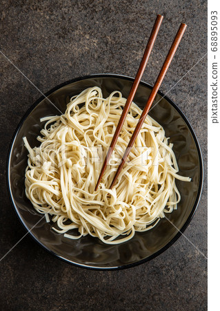 Cooked udon noodles. Traditional Japanese noodles. Cooked udon noodles. Traditional Japanese noodles. 68895093