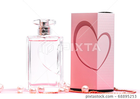 pink perfume bottle with pearls and a gold chain and a box on a pink sheet on a white background copy space. bot view, mockup 68895253