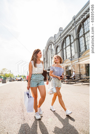Two young girls walking on a sunny day 68895486