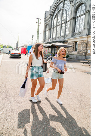 Two young girls walking on a sunny day 68895489