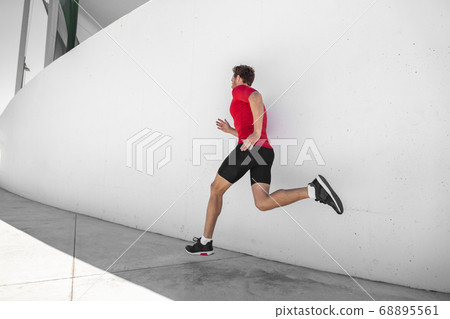 Athlete man running away sprinting doing cardio hiit workout exercise training at outdoor summer gym. Male runner jogging 68895561