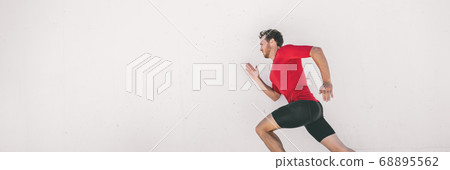 Running man runner training doing city run sprinting along wall outdoor white background. Male athlete profile doing sprint hiit high intensity interval training triathlon. Banner panorama Running man runner training doing city run sprinting along wall outdoor white background. Male athlete profile doing sprint hiit high intensity interval training triathlon. Banner panorama 68895562