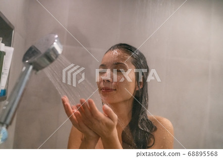 Shower woman showering at home bathroom with multi jest showerheads in modern shower with rainfall showerhead and handheld telephone 68895568