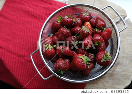 Fresh strawberries in an iron sieve 68895825