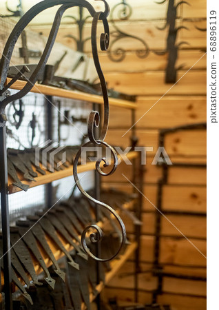 A shop or a museum of blacksmithing.The key hung on the wall. The forged curl. A shop or a museum of blacksmithing.The key hung on the wall. The forged curl. 68896119