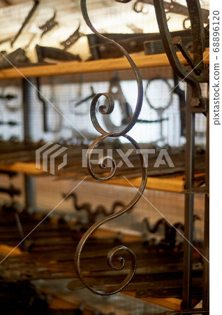 A shop or a museum of blacksmithing.The key hung on the wall. The forged curl. A shop or a museum of blacksmithing.The key hung on the wall. The forged curl. 68896120