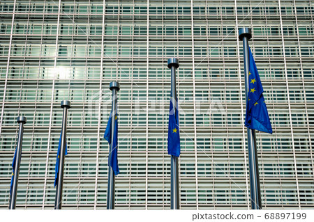 EU European Union flags in front of European Comission building in Background. Brussles, Belgium EU European Union flags in front of European Comission building in Background. Brussles, Belgium 68897199