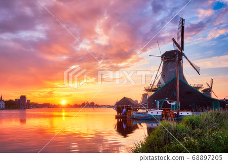 Windmills at Zaanse Schans in Holland on sunset. Zaandam, Nether 68897205