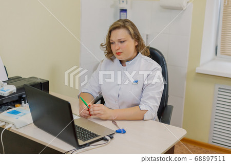 Woman neurologist at the computer in the office of 68897511