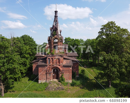 an old building with grass and trees,aerial photo 68898199