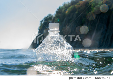 A plastic bottle floats on the water surface by the ocean. Ecology concept. A plastic bottle floats on the water surface by the ocean. Ecology concept. 68898265