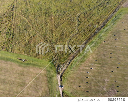rolls of hay on the field aerial photo 68898338