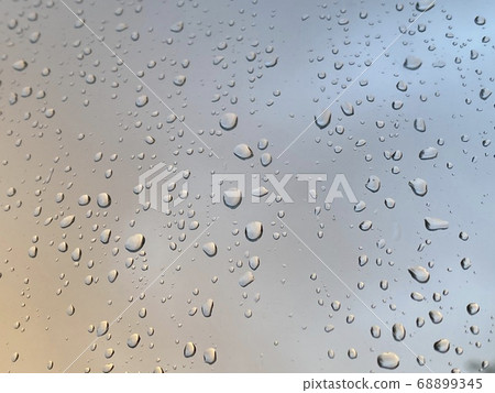 Water droplets on the glass with a background Water droplets on the glass with a background 68899345