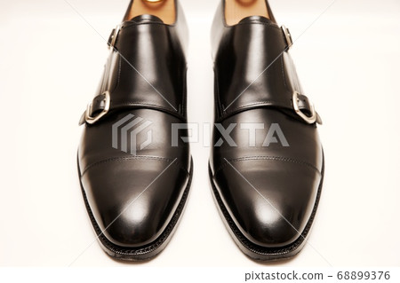 Black double monk strap leather shoes taken on white background Black double monk strap leather shoes taken on white background 68899376