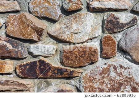 masonry wall paving stones as a background close up 68899936