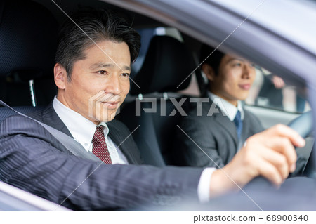 Businessman driving a car Businessman driving a car 68900340