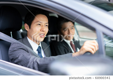 Businessman driving a car Businessman driving a car 68900341
