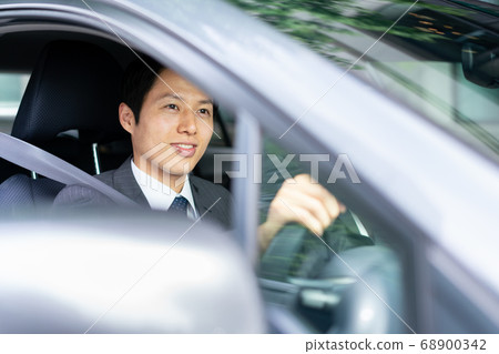 Businessman driving a car Businessman driving a car 68900342