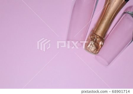 bottle of champagne with glasses on a pink background 68901714