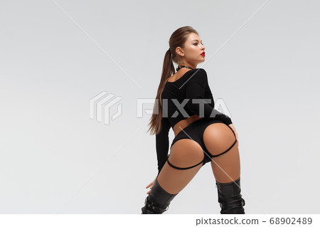 Alluring young woman in black underwear and boots 68902489