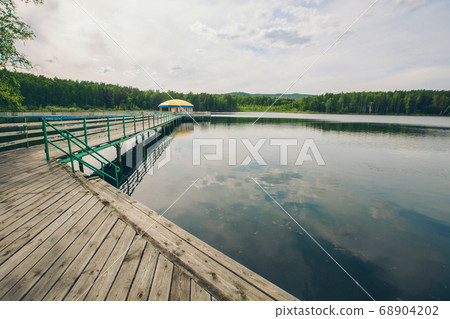 fishing bridge by the river. boat landing on the lake. water and transport 68904202