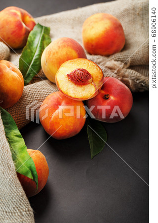 Peach fruit on a black background with a cloth of Peach fruit on a black background with a cloth of 68906140