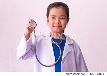 Asian girl playing doctor with stethoscope in 68906871