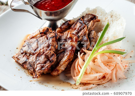 Grilled beef meat with rice and red sauce Grilled beef meat with rice and red sauce 68907970