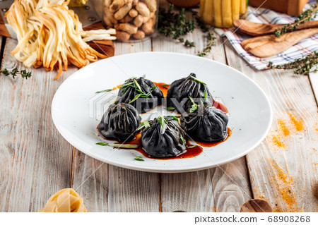 Chinese black dumplings with soy sauce Chinese black dumplings with soy sauce 68908268