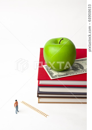 Miniature man with book and apple 68908633