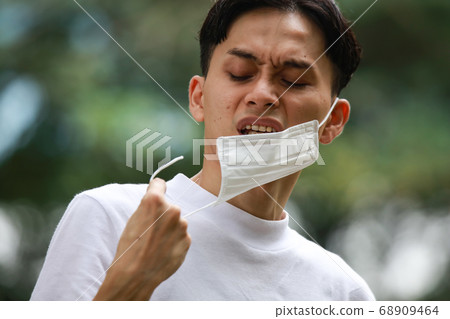 Man with broken mask 68909464